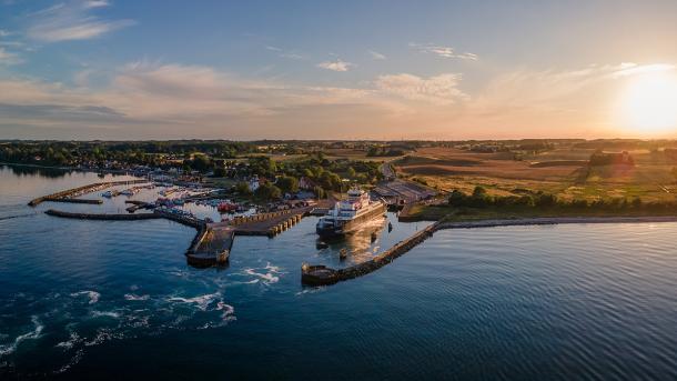 Aerial view of a ferry having just entered Spodsbjerg Harbour, Langeland on a sunny evening.